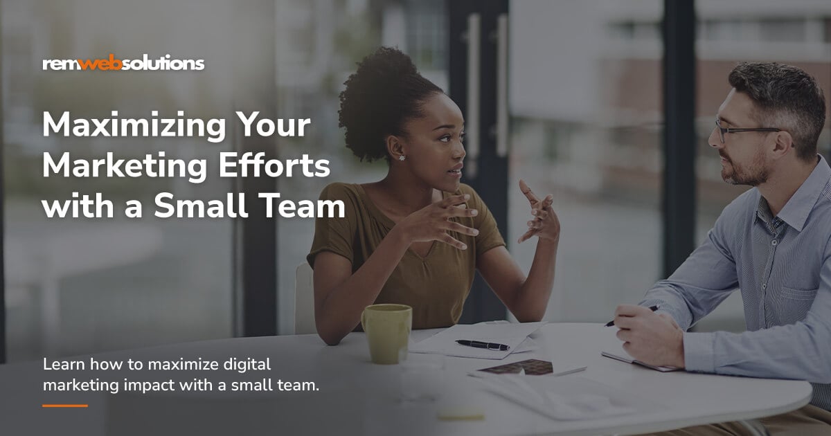 Small marketing team conversing at board room table